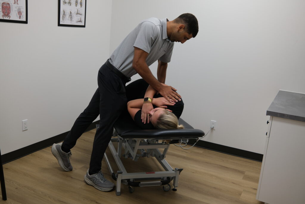 Dr Aden adjusting a patient's back