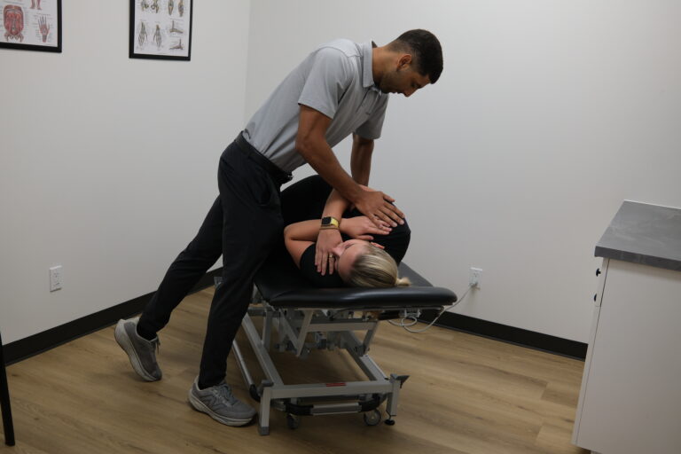 Dr Aden adjusting a patient's back