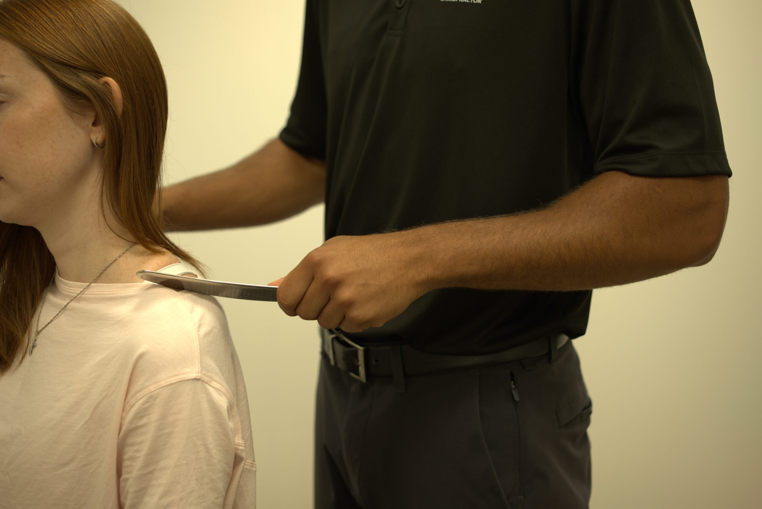 Chiropractor adjusting a patient's neck and back to ease pain