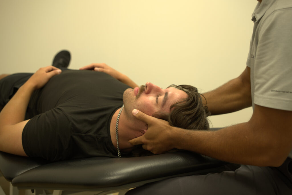 Dr Aden adjusting a patient's neck